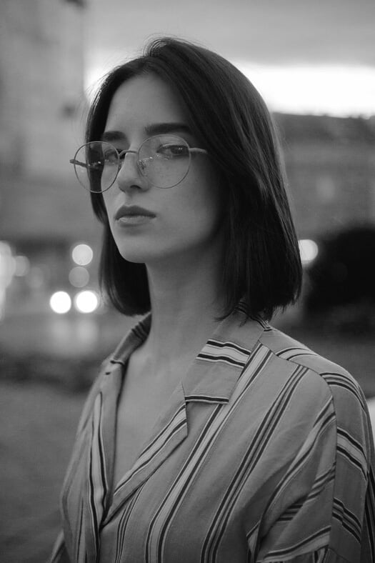 Shallow Focus Photo of Woman in Gray, White, and Brown Striped Button-up Shirt